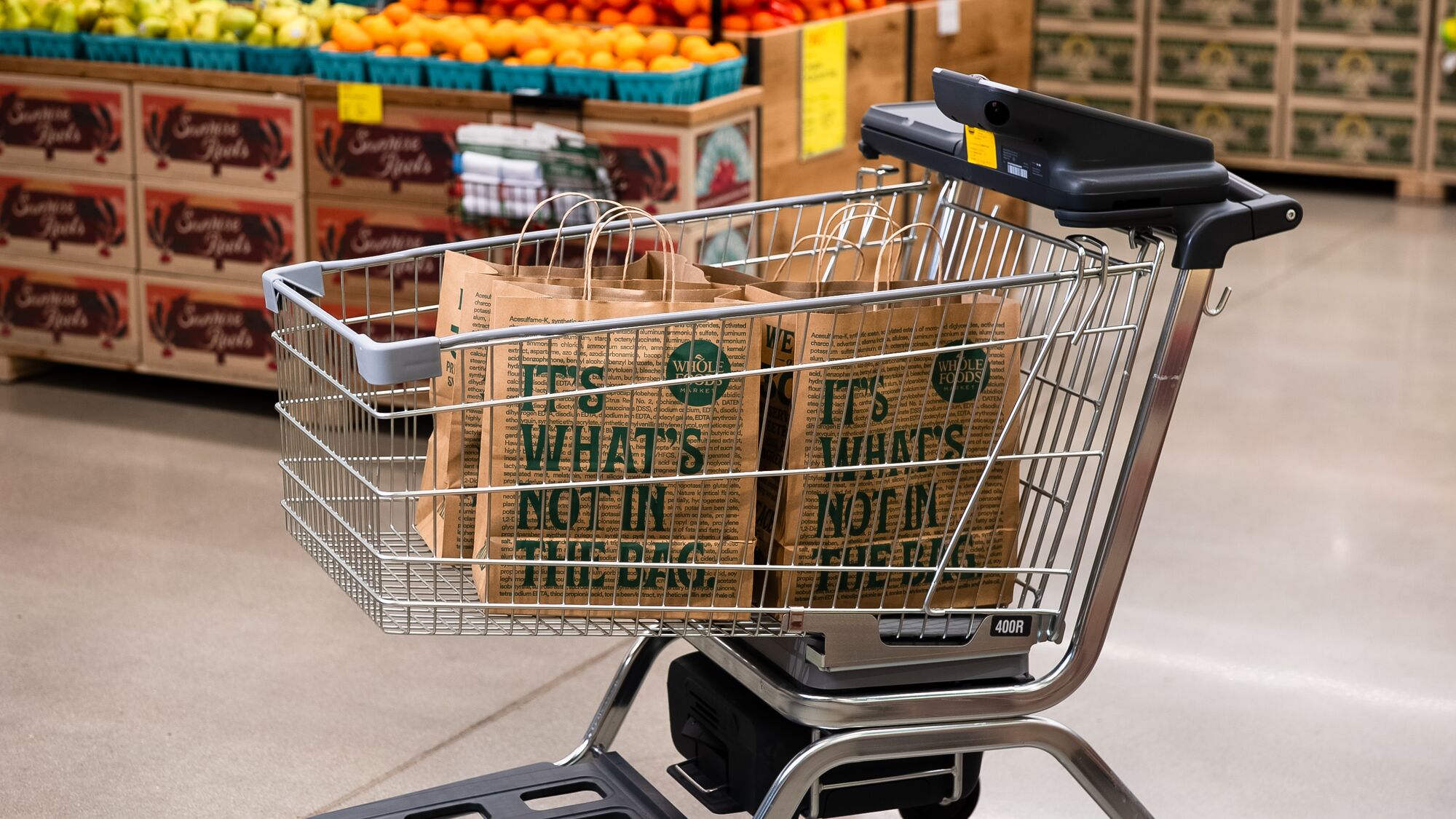 Dash Cart with Whole Foods bags in a produce aisle