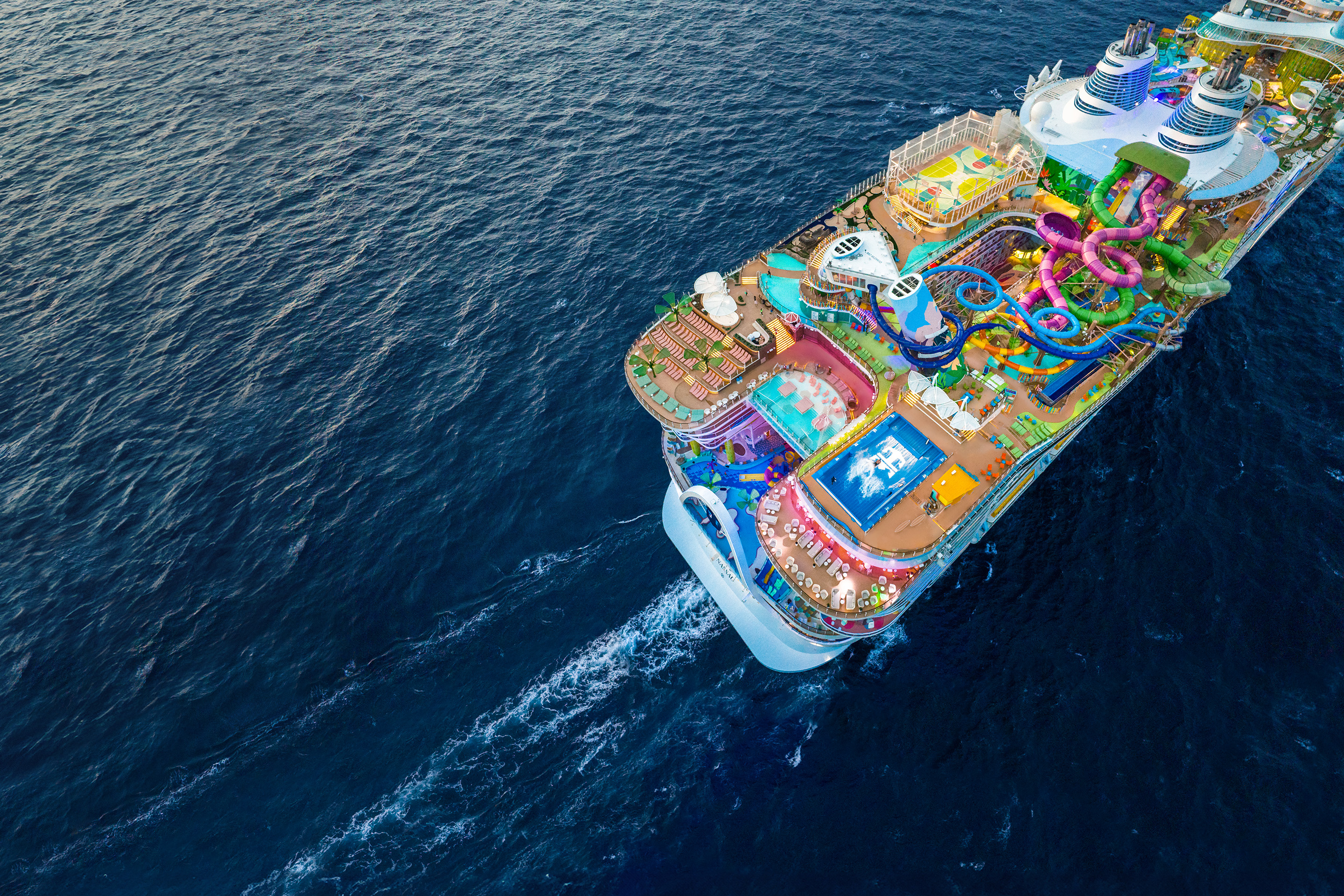 Icon of the Seas at sea, with the Royal Caribbean crown visible on the FlowRider deck
