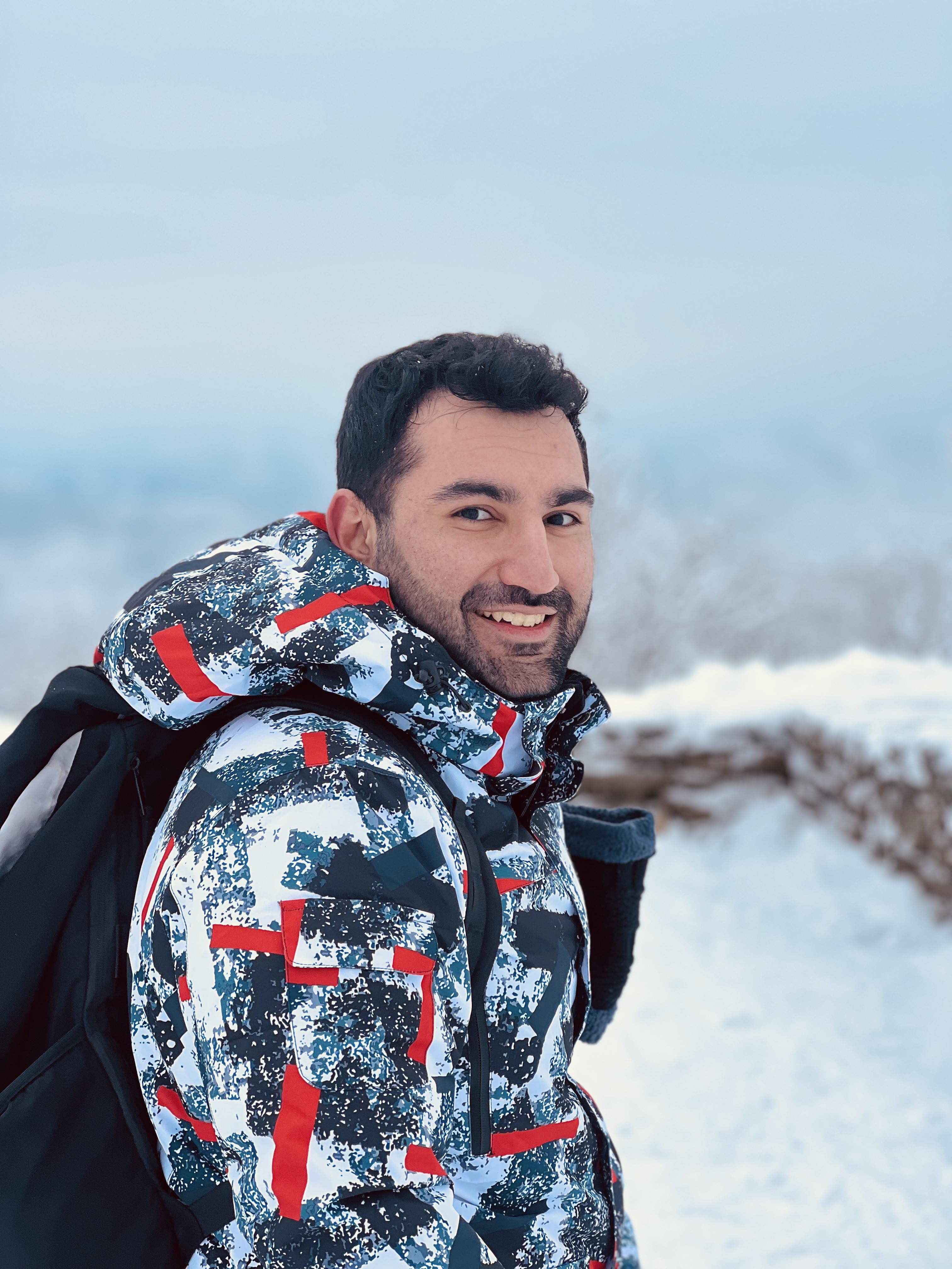 Huseyn outdoors in a snowy landscape